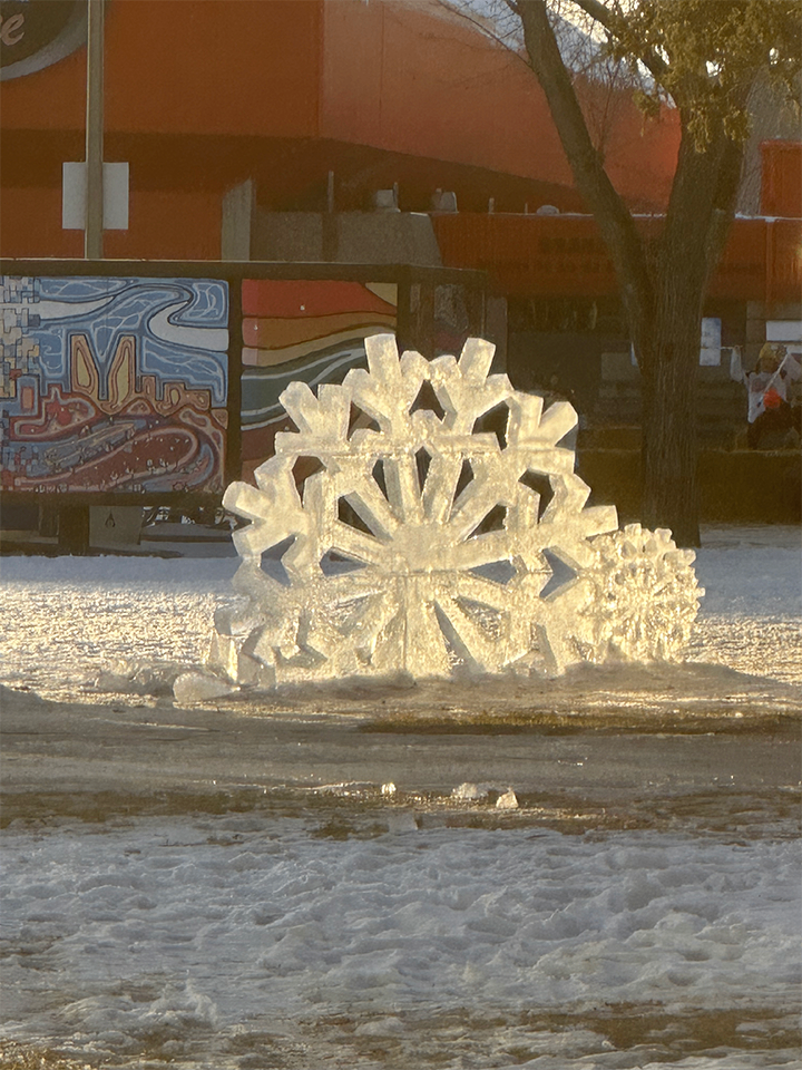 Giant snowflake ice sculpture at a festival