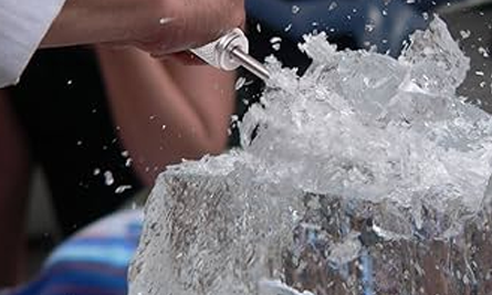 Ice carving workshop — chisel action close-up